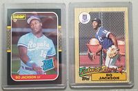 Front side of two Bo Jackson rookie cards from 1987 showing the Canadian Leaf version on the left and the Topps version on the right, both in protective hard cases.