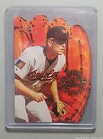 Front view of 1994 Flair Hot Gloves Cal Ripken Jr. die-cut insert featuring player image and glove design.