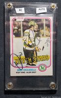 Front of Dino Ciccarelli 1981-82 O-Pee-Chee rookie hockey card #161 showing player in North Stars uniform, autograph with personalized '22' on front. Encased in protective plastic holder with labels 'RC' and 'AUTO'.
