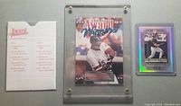Front view of Frank Thomas Donruss Award Winners card in protective holder and holographic Elite Series card with original paper sleeve.