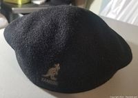 Front side showing the black wool beret with Kangol kangaroo logo embroidery.