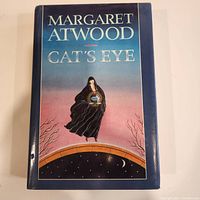 Front cover of Cat's Eye first edition hardcover showing full colorful jacket art with title and author's name.