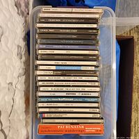 Photo of the full lot of music CDs arranged vertically in a storage container