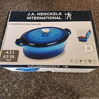 Box packaging showing the brand 'J.A. Henckels International', product description, 4.3L/4.5Qt capacity, oval shape, and blue color casserole photo and info.