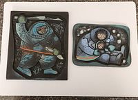 Pair of vintage hand-painted linoleum carvings showing the hunter and family scene.