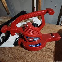 Red Toro Ultra Plus electric leaf blower shredder with handle and control knob visible