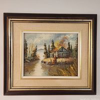 Oil painting in dark wood frame with golden trim and beige matting