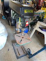 Overall view of Craftex CT023N drill press showing cast iron base, adjustable table, and drill head with brand logo.