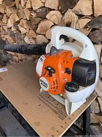 Side view showing orange and white housing, top handle and model label 'STIHL SH 56 C'