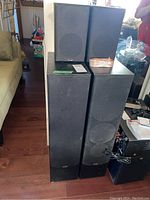 Four Paradigm speakers displayed together in a living room setting