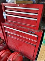 Front view of both chests stacked, showing drawer layout and cabinet door