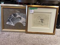 Both framed artworks side by side on carpet