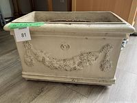 Full view of side with floral garland relief detail and overall cream colour.