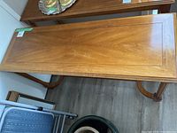 Top view of the wooden hall table showing the entire rectangular surface and part of the curved legs underneath.