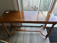 Front view of the wooden hall table showing entire piece with legs and stretcher.