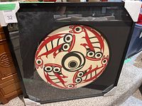 Overall view of framed circular print with protective corner guards