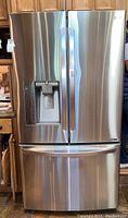 Full front view of LG French-door refrigerator with freezer drawer closed