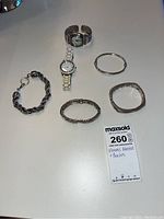 Overview of all watches and bracelets spread on a flat surface.