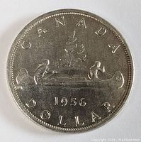 Full obverse side of the 1956 Canadian silver dollar showing the two voyageurs in a canoe, with 'CANADA DOLLAR' and year '1956' inscribed.