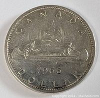 Front and back images of the 1966 Canadian silver dollar coin showing the Voyageur design.