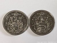 Two Canadian 50 cent coins showing the Canadian coat of arms and date 1968