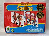 Front view of Match It! Spelling box showing colorful puzzle pieces and words, branding, and age recommendation