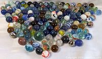Large collection of various colored spherical glass marbles