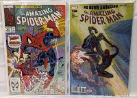 Photo of two Amazing Spider-Man comic books side by side, issue #327 and issue #788, both in protective sleeves.