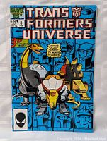 Front cover of the Transformers Universe comic book issue #3 showing dinosaur-themed Transformer robots and Marvel 25th Anniversary badge.