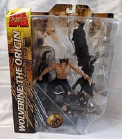 Front view of the sealed Wolverine Marvel Origin action figure in packaging, showing figure and detailed base.