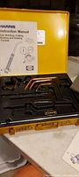 Harris welding torch tip set in yellow case with instruction manual visible.