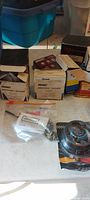 Photo of boxed GM billet steering wheel adapter kits and other boxed car parts on a table.
