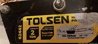 Photo of Tolsen label on the winch showing 2 ton capacity, cable size 5mm x 3m, and working length 55-180 cm