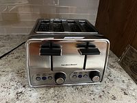 Front view showing two black levers, Hamilton Beach logo, and control panel with buttons and dials