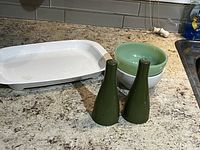 Photo of the Browning Grill, two bowls, and pair of green salt and pepper shakers on a kitchen counter.