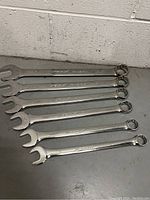 Six Mastercraft combination wrenches laid out, showing sizes and polished chrome finish.