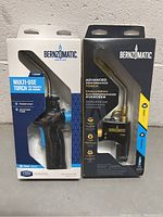 Front view of two Bernzomatic torches in original boxes, showing product names, features, and packaging.