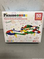 Front of box displaying Picasso Tiles Magnetic Building Block Race Track Set 50 pieces, for ages 3+