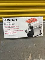 Photo of original box showing front with product image and features: heavy-duty 300-watt motor, precision thickness control, on/off switch with reverse, brushed stainless steel.