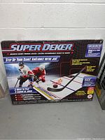 Original boxed Super Deker Advanced Hockey Training System with box showing graphics of hockey players and playing surface.