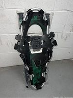 Front view of one Outbound snowshoe showing black straps, aluminum frame, and size 25 marking