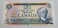 Front side of the 1979 Canadian five dollar bill showing the portrait of Sir Wilfrid Laurier, denomination, and security details.