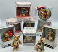 Image showing multiple boxed and loose Enesco Cherished Teddies figurines with various themes and packaging.