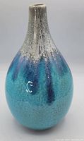 Front angled view of pottery vase showing textured glaze with blue and gray gradient