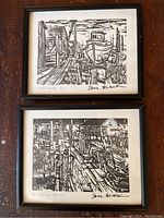 Two framed black and white prints by Sam Black showing dock scenes, one titled 'Winter Drydock B.C.' and the other 'Old Wharf Fraser River B.C.'