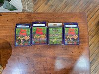 Four boxes of True Earth Patchouli cone incense arranged side by side on a wooden surface, showing front and back packaging.