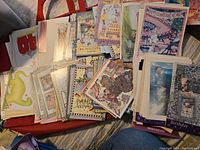 Top view of a spread of assorted vintage greeting cards and envelopes showing various colorful designs and text on cards.