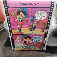 Photo of a vintage-style 1972 Pinocchio poster with two colorful cartoon scenes featuring Pinocchio and Jiminy Cricket, including a speech bubble with symbols and a 'Fluk Off!' exclamation.