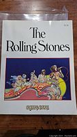 Front cover of The Rolling Stones 1975 book with band illustration