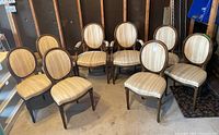 Group shot of eight matching chairs: six armless side chairs and two armchairs